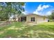 Spacious backyard with an enclosed fire pit area and lush green grass at 1934 Samantha Ln, Valrico, FL 33594