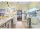 Bright bathroom featuring double vanity, walk-in glass shower, and luxury vinyl plank flooring at 1934 Samantha Ln, Valrico, FL 33594