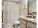 Traditional bathroom featuring neutral vanity, framed art, shell patterned shower curtain at 1934 Samantha Ln, Valrico, FL 33594