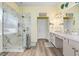 Modern bathroom featuring a glass-enclosed shower, double sinks, and elegant fixtures for a luxurious experience at 1934 Samantha Ln, Valrico, FL 33594