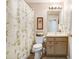 Cozy bathroom with a vanity, toilet, framed art, and decorative bamboo curtain at 1934 Samantha Ln, Valrico, FL 33594