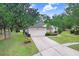 Beautiful home exterior with a well-manicured lawn, mature trees, and an attached two-car garage at 1934 Samantha Ln, Valrico, FL 33594