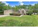 Charming single-story home featuring a manicured lawn, flowering bushes, and a welcoming entrance at 1934 Samantha Ln, Valrico, FL 33594