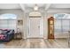 Bright foyer with a grandfather clock, an American flag, and windows with blinds at 1934 Samantha Ln, Valrico, FL 33594