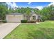 Charming single-story home with a well-manicured lawn, attached garage and meticulously landscaped front yard and walkway at 1934 Samantha Ln, Valrico, FL 33594