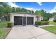 Attached garage with a long driveway and front garden area at 1934 Samantha Ln, Valrico, FL 33594