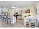 Bright kitchen with granite countertops, stainless appliances, bar seating, and an adjacent dining area at 1934 Samantha Ln, Valrico, FL 33594