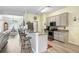 An open kitchen featuring granite countertops, stainless steel appliances, and bar stool seating at 1934 Samantha Ln, Valrico, FL 33594