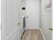 Laundry area with washer and dryer, access doors, and “Laundry, the never ending story” wall decor at 1934 Samantha Ln, Valrico, FL 33594