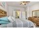 Comfortable bedroom featuring a queen bed, a ceiling fan and two access doors to the main bath and walk-in closet at 1934 Samantha Ln, Valrico, FL 33594