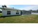 Spacious backyard featuring a screened-in pool, perfect for outdoor relaxation and entertainment at 1961 Dunbrody Ct, Dunedin, FL 34698
