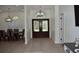 Elegant foyer features double doors with glass inserts, light hardwood floors and an archway at 1961 Dunbrody Ct, Dunedin, FL 34698