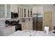 Elegant kitchen with stainless steel appliances, white cabinetry, and marble countertops at 1961 Dunbrody Ct, Dunedin, FL 34698