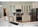 Contemporary kitchen with stainless steel appliances, white cabinets, and marble countertops at 1961 Dunbrody Ct, Dunedin, FL 34698