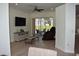 Contemporary living room with hardwood floors, sliding glass doors to the lanai, and modern furniture at 1961 Dunbrody Ct, Dunedin, FL 34698