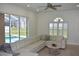 Inviting living room featuring a large window overlooking the pool and a comfortable white couch at 1961 Dunbrody Ct, Dunedin, FL 34698
