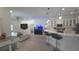 Spacious living room with a kitchen island, sofa, and hardwood floors at 1961 Dunbrody Ct, Dunedin, FL 34698