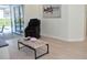 Modern living room featuring hardwood floors, a marble top table and sliding glass doors at 1961 Dunbrody Ct, Dunedin, FL 34698