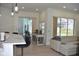 Open floor plan with a kitchen island, sofa, and sliding doors to the pool at 1961 Dunbrody Ct, Dunedin, FL 34698