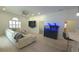 Bright living room with light hardwood floors, fan, and modern fish tank at 1961 Dunbrody Ct, Dunedin, FL 34698