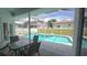 Covered patio with outdoor seating area overlooking a screened in pool at 1961 Dunbrody Ct, Dunedin, FL 34698