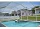 Screened-in pool and attached spa in backyard at 1961 Dunbrody Ct, Dunedin, FL 34698