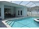 Inviting screened in pool with jacuzzi, steps and stone coping at 1961 Dunbrody Ct, Dunedin, FL 34698