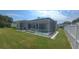 Enjoy the Florida weather in this screened-in pool and spa with lush green surroundings at 1961 Dunbrody Ct, Dunedin, FL 34698