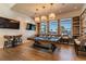 Game room features a pool table, mounted televisions, wood flooring, and natural light at 20033 Sea Glass Cir, Land O Lakes, FL 34638