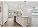 The large kitchen island with sink offers views to the great room in this open floor plan at 20033 Sea Glass Cir, Land O Lakes, FL 34638