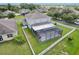 A full aerial view of this home with a screened in patio, surrounded by a well manicured lawn at 20102 Oakflower Ave, Tampa, FL 33647