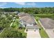 Expansive aerial view of a well-maintained home, landscaping, and a serene pond nearby at 20102 Oakflower Ave, Tampa, FL 33647