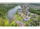 Panoramic aerial showcasing pond-front homes, offering scenic views and community charm in a lush, green landscape at 20102 Oakflower Ave, Tampa, FL 33647