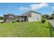 Green backyard with a fenced-in patio area and mature landscaping at 20102 Oakflower Ave, Tampa, FL 33647