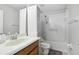 Well lit bathroom featuring a large mirror, single sink, bathtub, shower, and a toilet at 20102 Oakflower Ave, Tampa, FL 33647