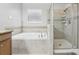 Bathroom with a soaking tub, glass enclosed shower and neutral color scheme provides a luxurious experience at 20102 Oakflower Ave, Tampa, FL 33647