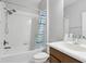 Clean bathroom with tub and shower, plus vanity with updated faucet fixtures at 20102 Oakflower Ave, Tampa, FL 33647