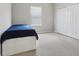 Simple bedroom with a single bed, window, and a closet for plenty of storage space at 20102 Oakflower Ave, Tampa, FL 33647