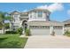 Charming two-story home with a three-car garage and well-manicured lawn and landscaping at 20102 Oakflower Ave, Tampa, FL 33647