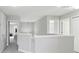 Upstairs hallway with neutral walls, carpet and white doors allows for natural light throughout at 20102 Oakflower Ave, Tampa, FL 33647