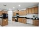 Well-lit kitchen with granite countertops, wooden cabinets, and modern appliances for cooking at 20102 Oakflower Ave, Tampa, FL 33647