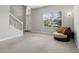 Inviting living room with a large window, neutral carpet and chair to create a comfortable atmosphere at 20102 Oakflower Ave, Tampa, FL 33647