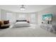 Expansive bedroom features large windows for natural light and a cozy sitting area, perfect for relaxation at 20102 Oakflower Ave, Tampa, FL 33647
