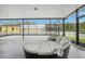 Large screened patio with ample seating and a basketball hoop for recreation at 20102 Oakflower Ave, Tampa, FL 33647