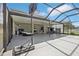 Large screened patio with lounge areas and basketball hoop, perfect for fun and relaxation at 20102 Oakflower Ave, Tampa, FL 33647