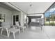 Spacious screened-in patio with comfortable seating and swing, perfect for relaxing at 20102 Oakflower Ave, Tampa, FL 33647