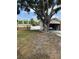 View of backyard and exterior; large tree provides shade at 2026 Aaron Pl, Clearwater, FL 33760