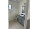 Standard bathroom with a toilet, sink and vanity, and a tiled floor at 2026 Aaron Pl, Clearwater, FL 33760