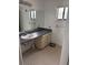 Modest bathroom featuring a single sink vanity and a large mirror above at 2026 Aaron Pl, Clearwater, FL 33760