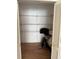 Empty closet with white shelving and an organized pile of clothing at 2026 Aaron Pl, Clearwater, FL 33760